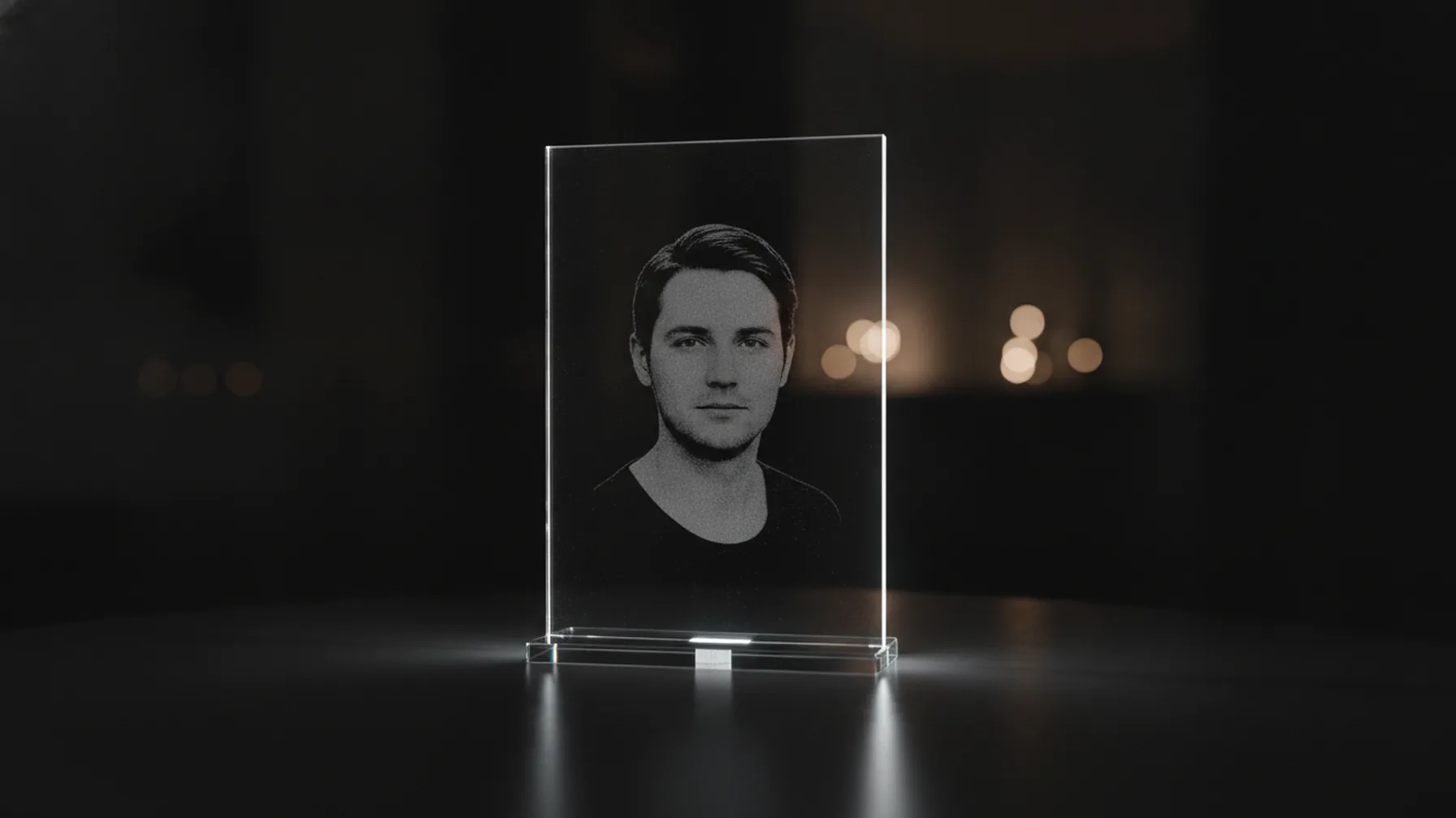 Blocco di plexiglass trasparente 13x18 cm con ritratto in bianco e nero inciso al laser, su basetta scura e scrivania in rovere